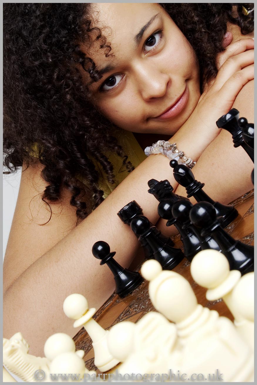 Studio Portrait of a girl and chess board