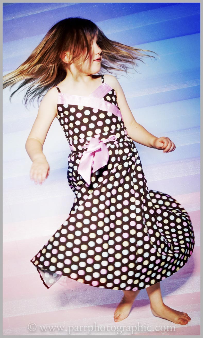 Studio Portrait of a girl spinning with photoshop manipulation