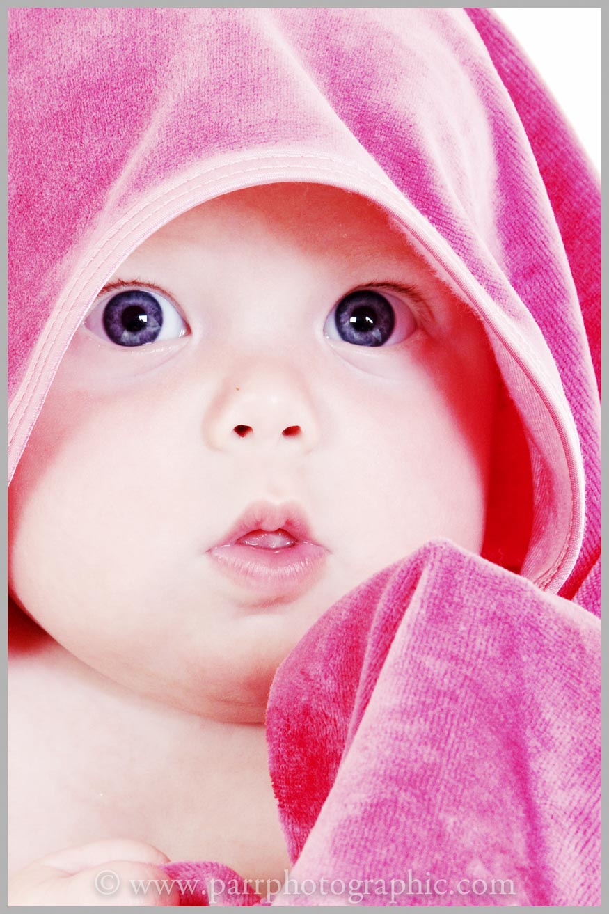 Studio Portrait of a baby with a pink towel