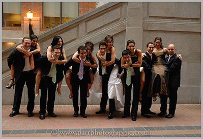 Wedding party brides maids get piggybacks form the best men