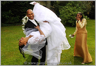 Bride is being tipped upside down by the groom