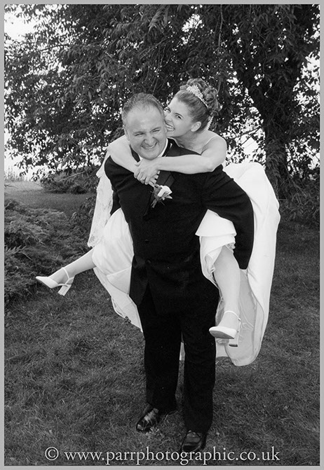 Bride gets a piggy back from the groom