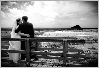Bride and groom on a bridge on Wembury beach Devon