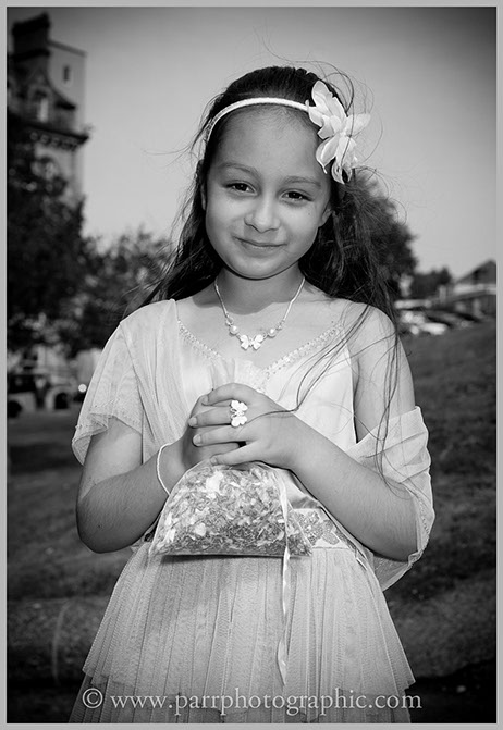 Flower girl holds a bag of petals
