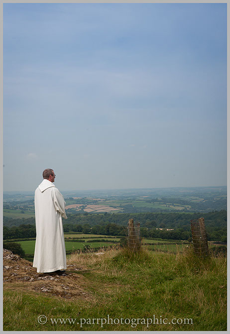 Vicar looks out over the view waiting for the bride at Brentor